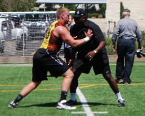 NFL Hall of Fame football player Jackie Slater is an assistant coach at APU. Here he works with a player during their NFL Pro Day.